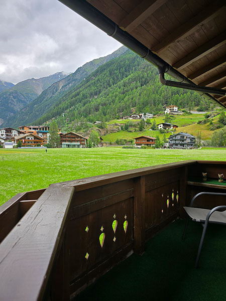 View of the meadow in front of Apart Tyrolis with the Ötztal mountains in the background